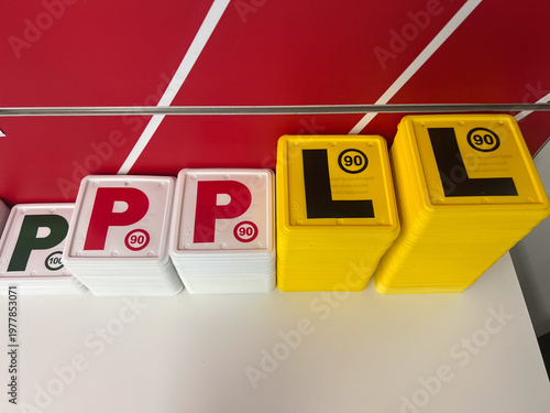 Australian Learner and Provisional Driver Plates on Table in Licensing Office