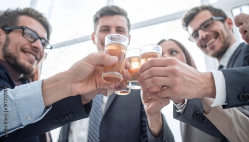Business colleagues toasting with drinks in office.
