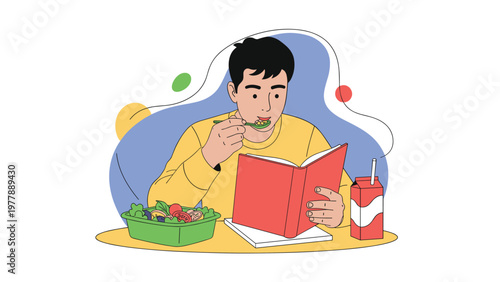 Young male student eating a healthy salad and drinking milk while focused on reading a book at a wooden table.