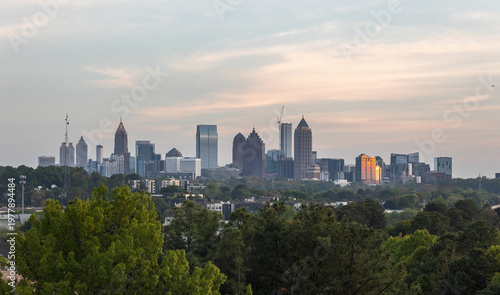 View of the Downtown and Midtown Atlanta Skyline Cityscape showing several prominent buildings, trees, and hotels on a beautiful clear night.