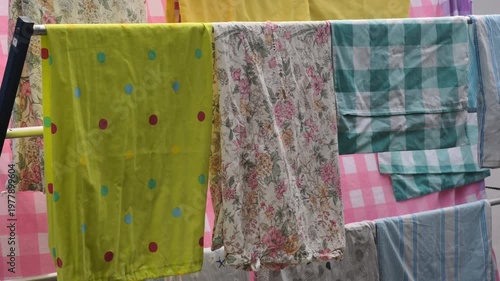 Assorted Colorful Laundry Drying On A Clothesline With Bright Sunlight And Gentle Breeze