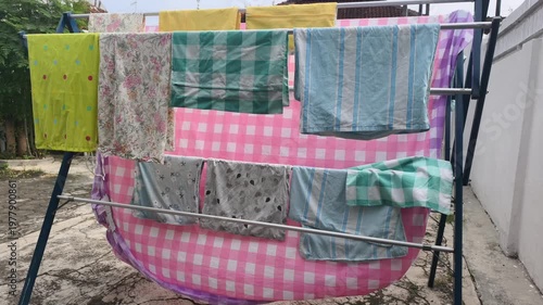 Colorful Assortment Of Wet Laundry Drying On A Clothesline On A Cloudy Day