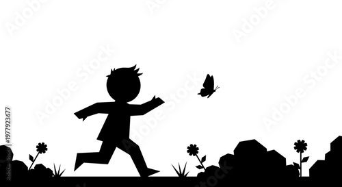 Silhouette of child chasing butterfly.