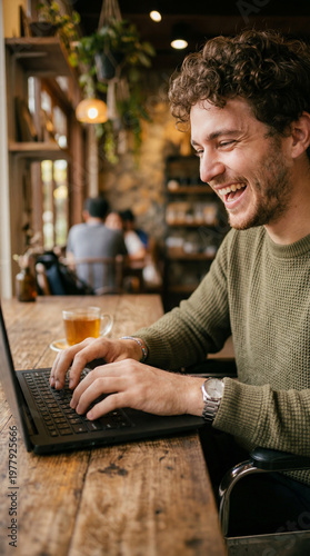 A man with a laptop, tea cu...