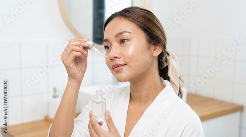 A radiant woman applies ser...
