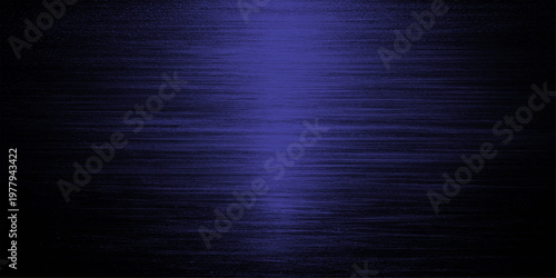 Abstract a textured dark blue metallic surface, the image captures the subtle play of light across the rough surface, creating a visual depth.