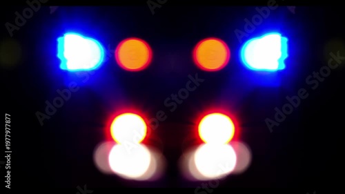 defocused video of the sires of a police squad car outside in the night