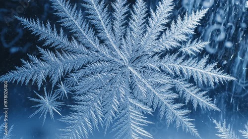 Intricate snowflake crystal formation on dark blue background, macro detail