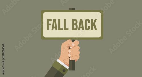 Hand holding a sign that says FALL BACK, concept of retreat or step back