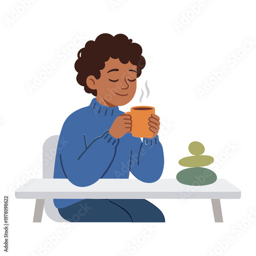 A woman enjoys a hot beverage while sitting with a zen stone stack nearby.