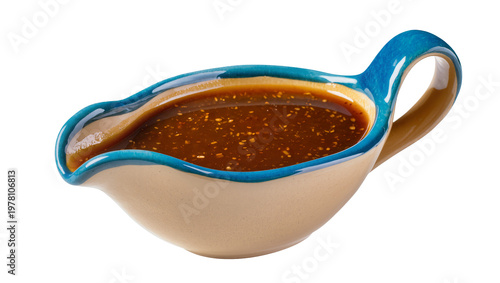 Bild auf Leinwand Blue rimmed ceramic gravy boat filled with brown sauce