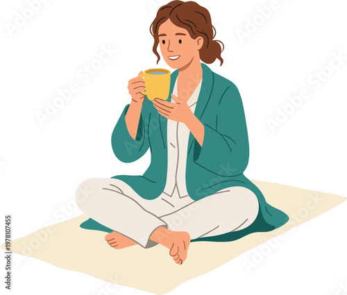 Woman sitting cross-legged on a mat enjoying a cup of coffee indoors