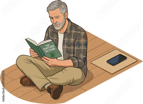 Man sitting on floor reading book next to phone on mat indoors