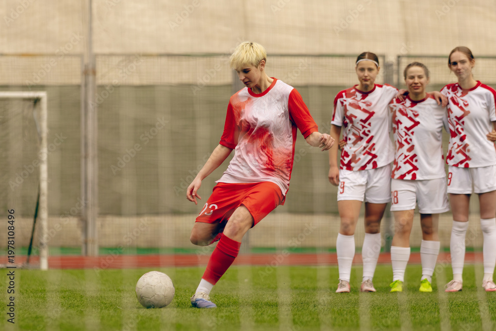 Fototapeta premium Young woman soccer players play football.