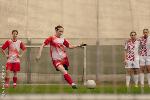 Canvas Print Young woman soccer players play football.