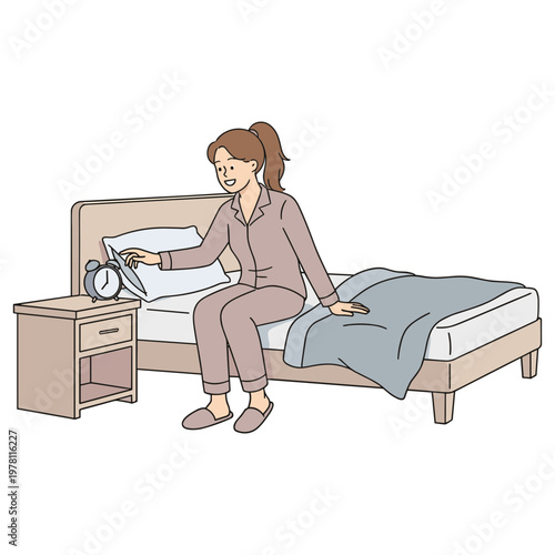 A woman in pajamas sitting on a bed checking an alarm clock.