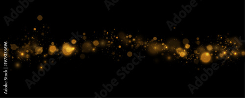 Bright gold bokeh lights scatter across dark space with soft glowing effect. Sparkling dust forms festive luxury texture. Perfect holiday graphics overlay.