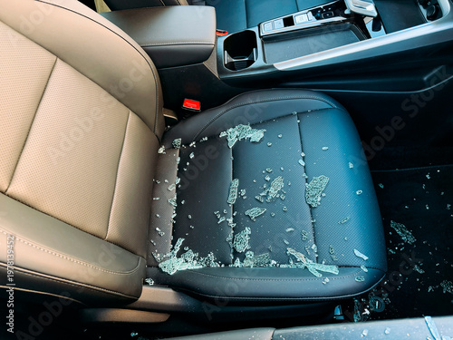 Close up of car seat covered with glass fragments.