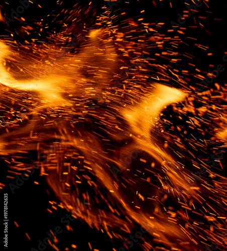 A fire is burning and the sparks are flying