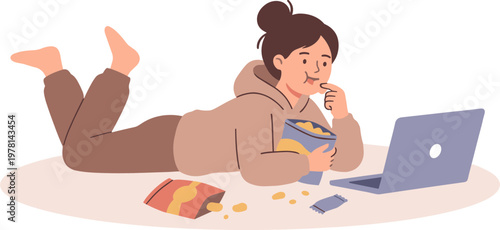 Woman lies on floor eating snack while browsing laptop with book