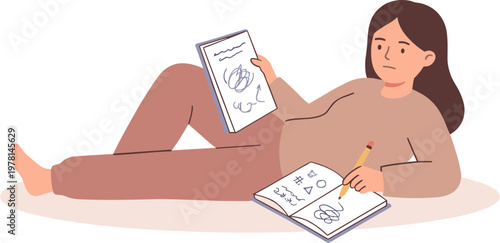 Woman reclines on floor reading book and writing notes with pencil