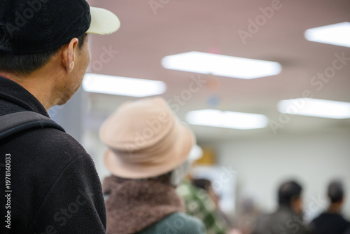 People attending an event in community centre. Unrecognizable senior audience in the room. California.