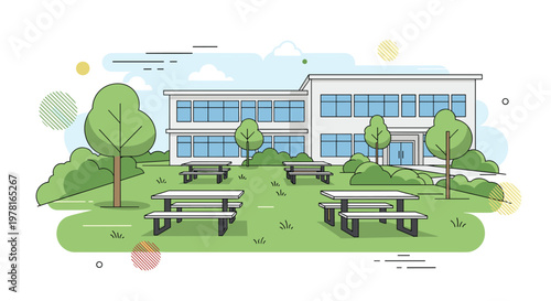 Modern school building stands behind a green grassy courtyard featuring several wooden picnic tables for students to rest and socialize.