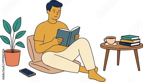 A man sits in a chair reading a book next to a plant and table with books and coffee