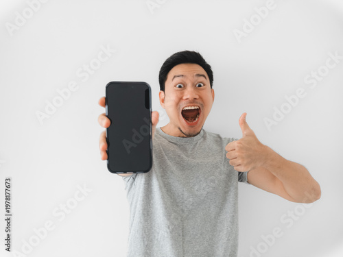 Asian man in gray shirt happily endorsing with thumbs up and smile