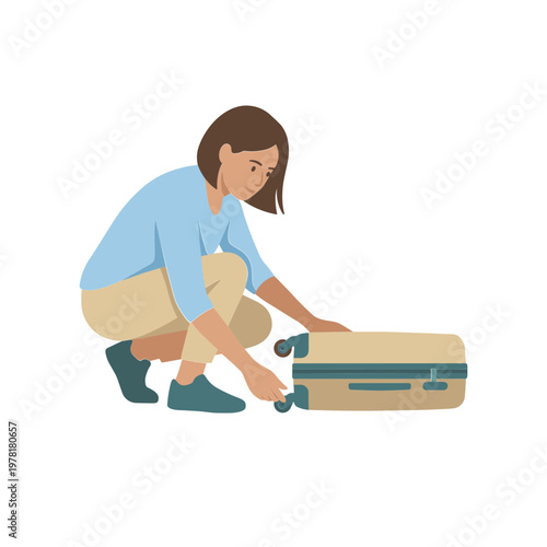 Woman crouches beside a suitcase and zips it shut carefully outdoors.