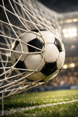 Close up of a soccer ball hitting the net in a stadium for a goal.