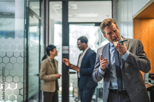 Konstfotografi Businessman recording audio message on smart phone in office