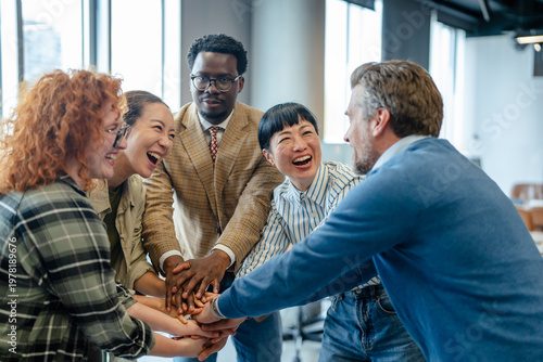 Diverse business team stacking hands for unity and success