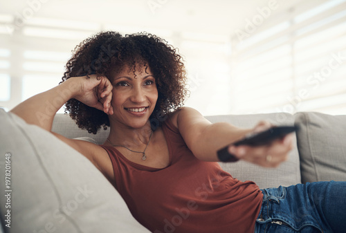 Fotografía Relax, streaming and watching tv with woman on sofa in home living room for subscription service