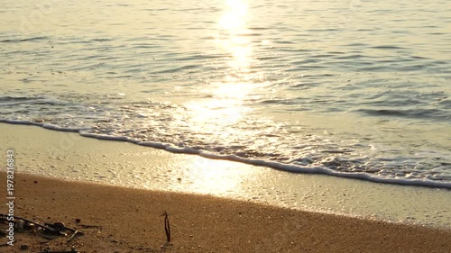 Golden hour sunset reflection on beach shore