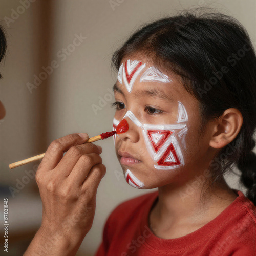 Indigenous woman painting face with red achiote
