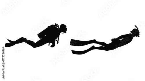 Two divers swimming underwater a striking black shape silhouette