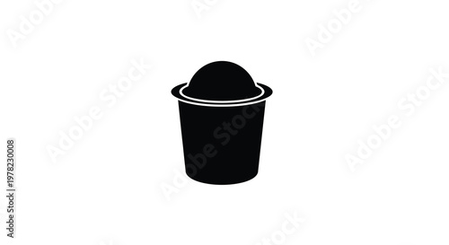 Simple black silhouette of a coffee capsule or pod with a circular design