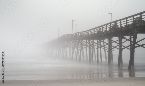 view of the Surf City fishing pier and beach during a spring morning with thick fog