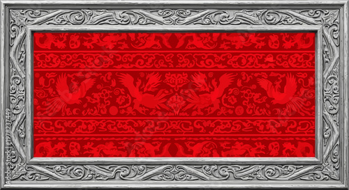 Intricate silver frame with red patterned insert.