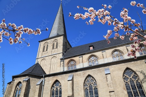 Moenchengladbach church in Germany. Spring time cherry blossoms.