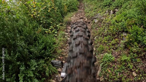 POV Unicycle Wheel Rolling On Wet Mountain Trail Slow Motion