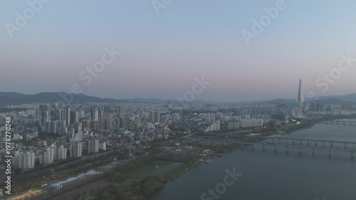 Aerial night view of the illuminated Seoul skyline and Han River from Gwangjin-gu, South Korea.