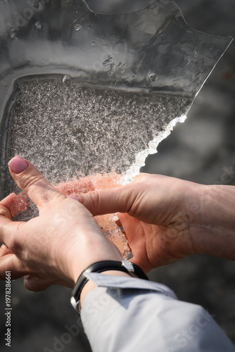 Hands Holding Transparent Ice Piece With Air Bubbles Vertical Spring Ecology Concept