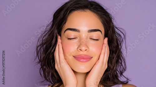 Young woman with curly hair blissfully enjoying self-care moment against soft purple background with serene expression