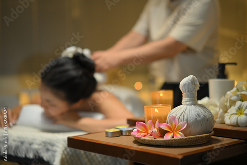Принти на полотні Focus on spa equipment and relaxing candlelight woman receiving traditional herb