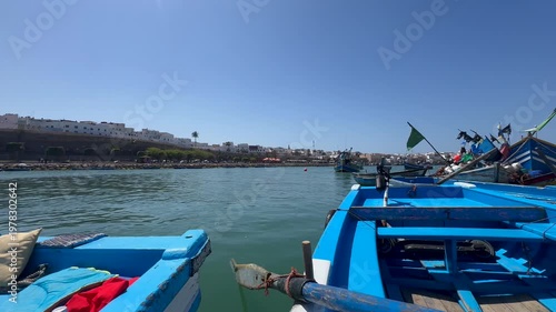 Rabat, morocco 26 march 2026: 4K video of A picturesque vintage sunrise at the ancient fishing port of Rabat, Morocco. Traditional blue boats in the harbor over the historical med