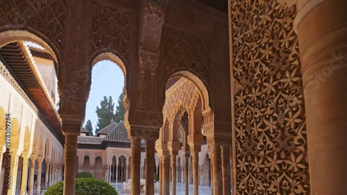 Magnificent stone carvings decorate the arches of Alhambra palace in Granada. Detailed view of the Moorish architecture in the Court of Lions in Alhambra. Gimbal shot, 4K