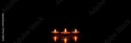 Oil lamps glowing in darkness, Indian festival Diwali lights, minimal banner with copy space.