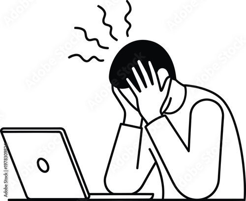 A man sitting at a laptop with his head in his hands